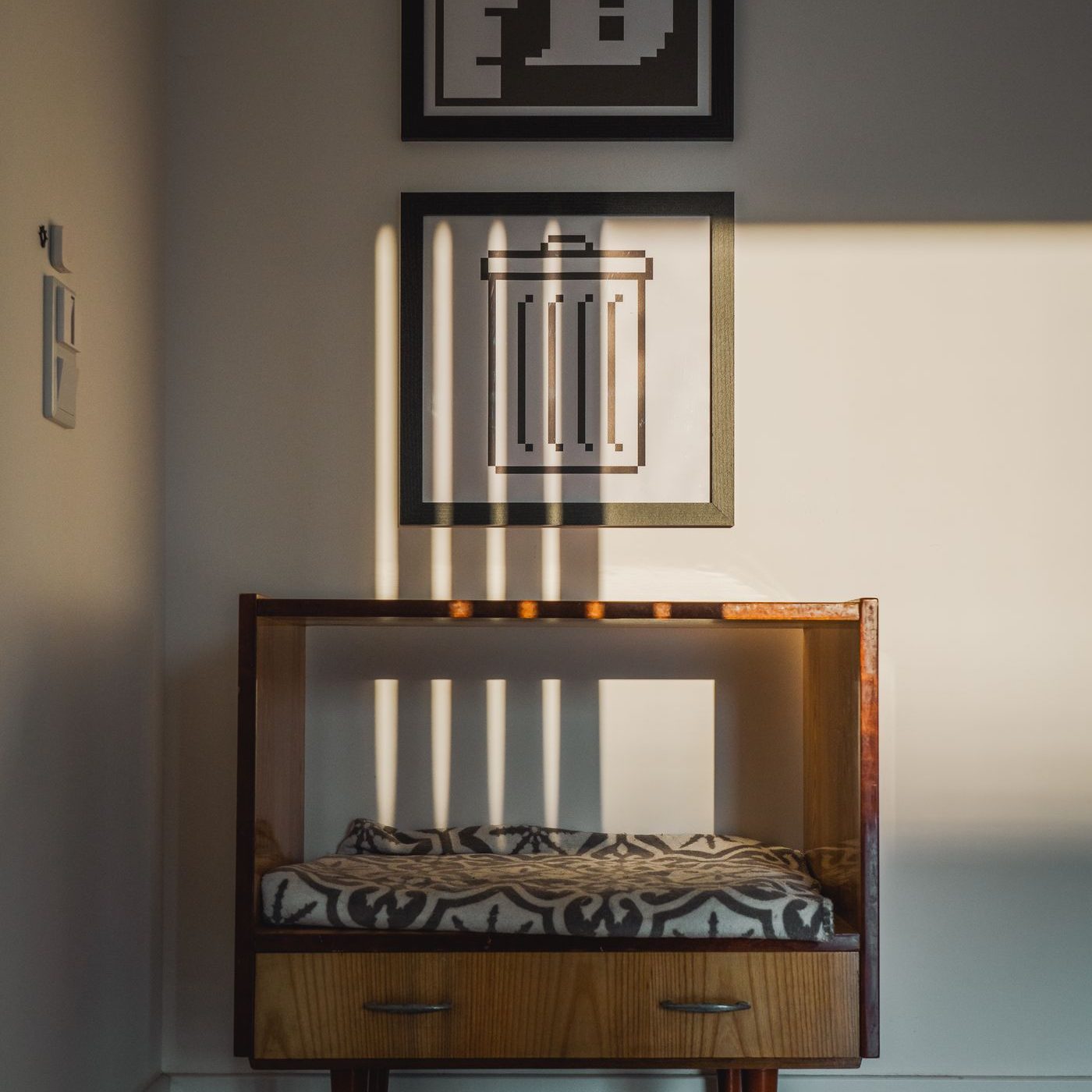 A console table against a wall with a framed work above it