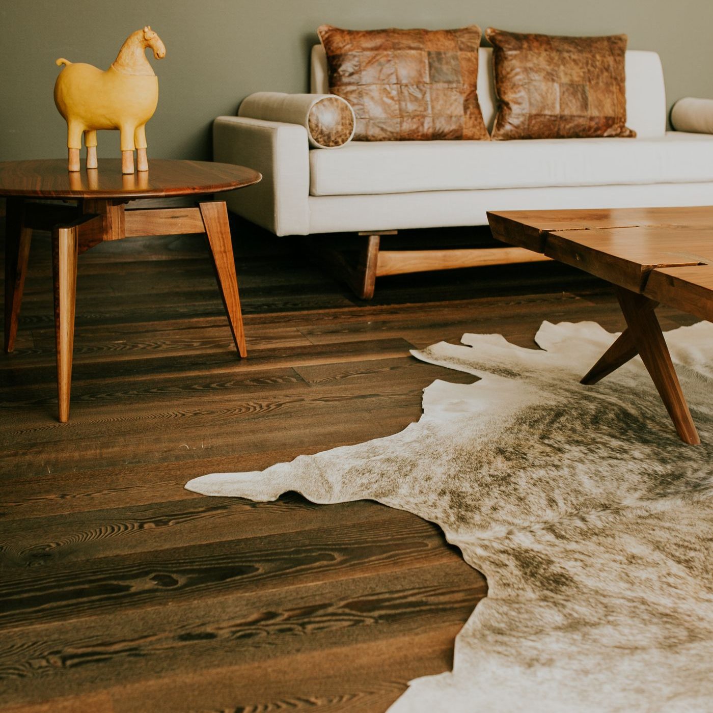 A wood table on a textured hide rug, seen from above