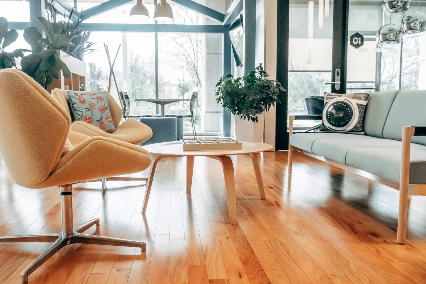 A bright split-level living area with wood floors and plants
